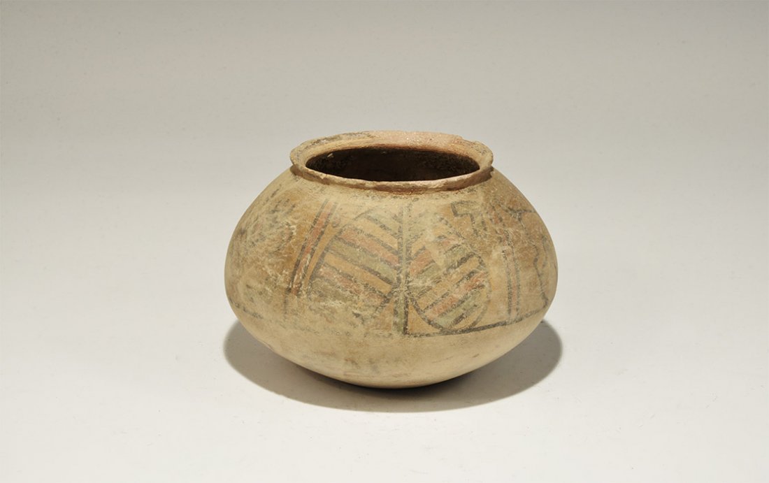 Indus Valley Mehrgarh Polychrome Ceramic Jar with Birds: 3300-1700 BC. A squat terracotta jar with chamfered rim, band of polychrome ornament to the shoulder with peepal leaf, bird and ox. 285 grams, 13cm (5"). Private collection, Cambridgeshire, UK; acquir