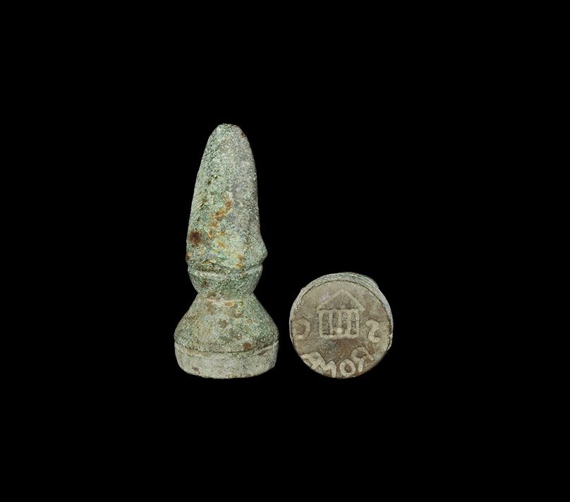 Roman Style ROMA and Temple Stamp Seal: 20th century AD. A gussetted cylindrical stamp seal with D-shaped handle; intaglio design to the underside of a temple façade with 'S.C' flanking and 'ROMA' beneath (M and A in ligature). 81 grams, 5