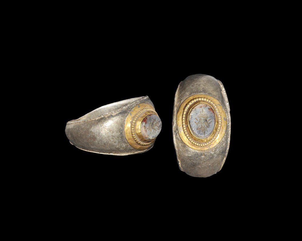 Roman Ring with Fly Intaglio: 1st-2nd century AD. A D-section silver parcel-gilt hoop with slightly flared edges, discoid cell with beaded wire border, inset jasper intaglio of a fly. Cf. Ruseva-Slokoska, L. Roman Jewellery, Sofia
