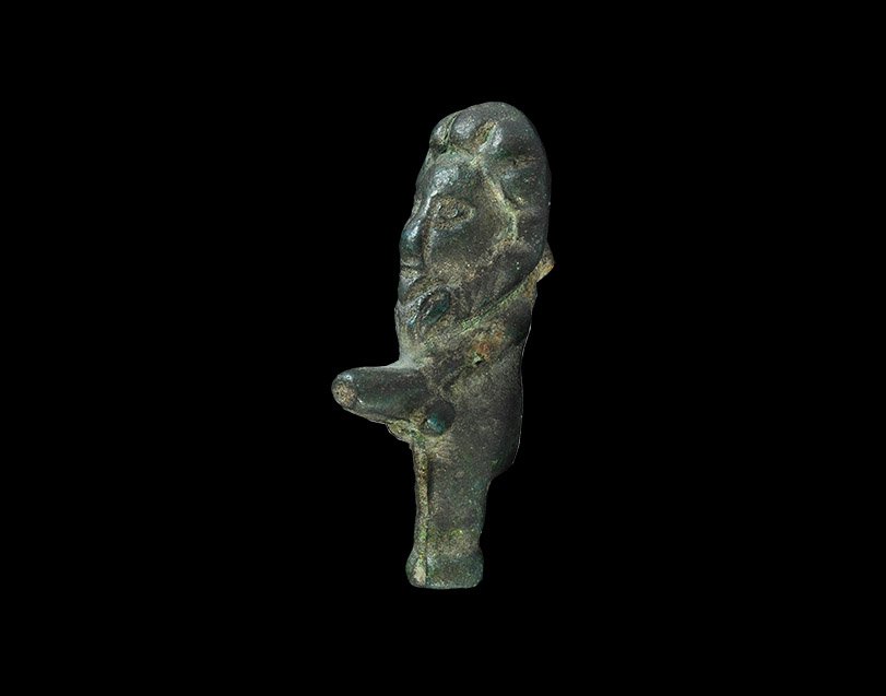 Roman Mithraic Amulet: 2nd-3rd century AD. A bronze figurine in the form of an ithyphallic figure with lion's head; iron fixing stud to the reverse. In the mystery cult of Mithras, a Persian deity popular in the Roman Empir
