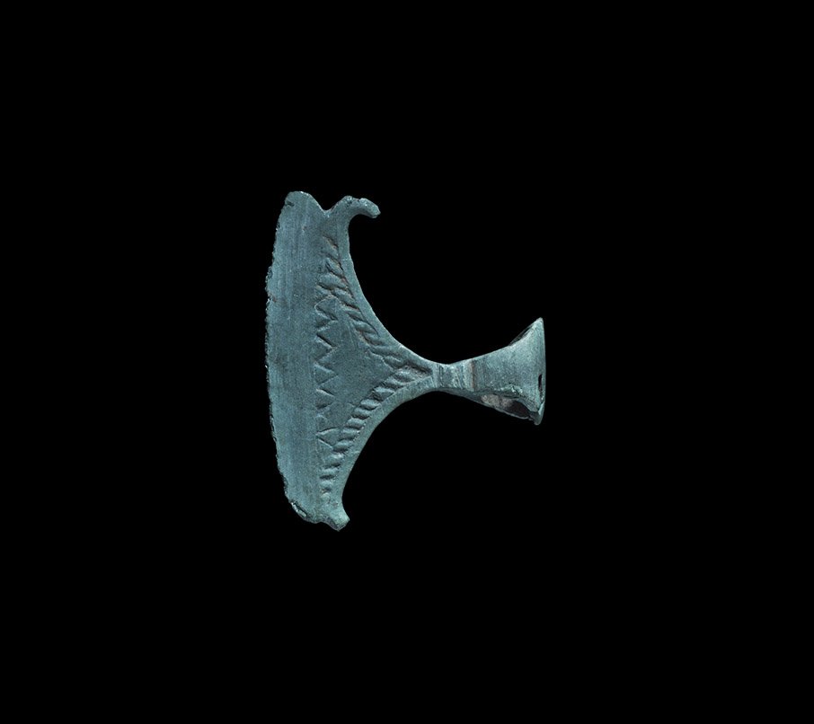 Viking Decorated Broad Axe Pendant: 11th-12th century AD. A curved miniature bronze axe-head Scandinavian type pendant (also widespread in the historical Rus region), with a long slicing blade and recurved horns to the inner edges; punc