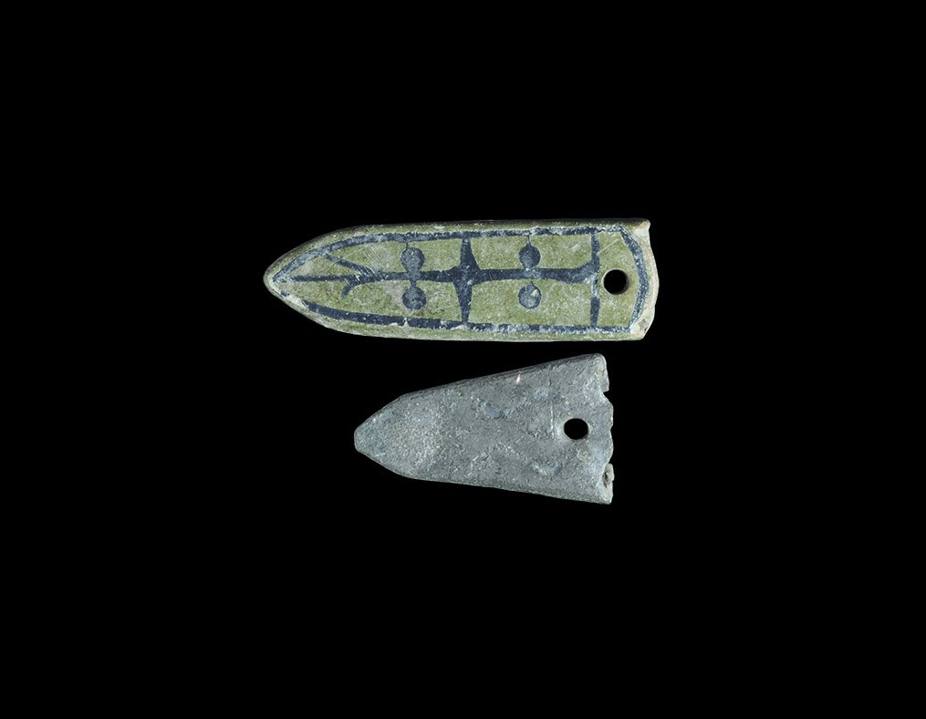 Viking Ladder Strap End Group: 9th-12th century AD. A pair of bronze strap end comprising: one tongue-shaped with niello ladder ornament; one triangular with punched scrolls. 11 grams total, 25 - 38mm (1 - 1 1/2"). Property of an A