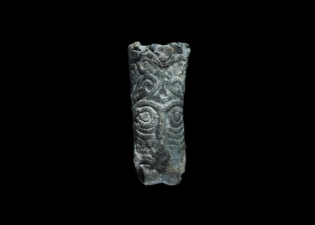 Viking Beast-Head Terminal: 9th-11th century AD. A tubular lead terminal with raised beast-head detailing to each face, pierced tranversely at the lower edge to accept a ring, pierced at the upper edge with a fixing pin. 9.86 gr