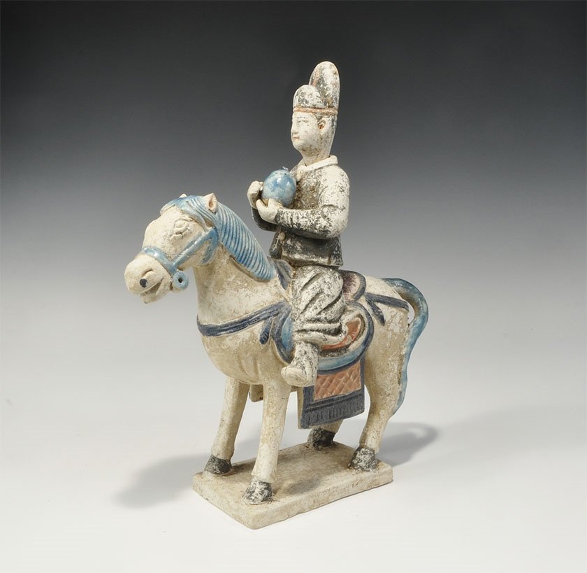 Chinese Blue-Glazed Processional Horseman Figurine: An undated archaistic glazed ceramic horse and rider figurine in Ming Dynasty, 1368-1644 AD style comprising: a standing horse on a rectangular base with integral saddle and horseman's body, hands rai