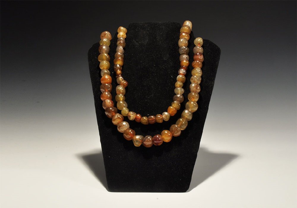 Indian Bead Necklace: 20th century AD. A restrung necklace of graduated irregular hand shaped and drilled carnelian beads. 495 grams, 138cm (54 1/4"). From a central London collection formed between 1990-2000.[No Reserve]