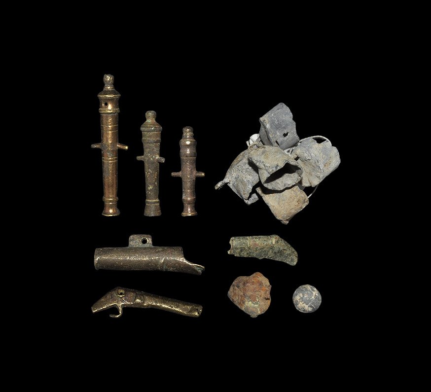 Post Medieval Toy Cannon and Gun-Related Items Group: 18th-19th century AD. A mixed group of detector finds comprising: five lead measures for black powder; three barrels for toy cannons, each with lateral trunnions; a Tudor petronel and a fragment of an