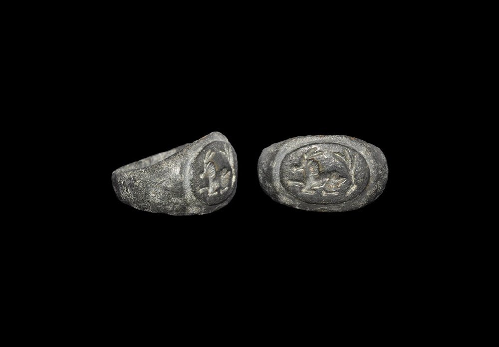 Roman Ring with Antelope: 3rd century AD. A D-section bronze hoop expanding to an elliptical bezel with motif of a recumbent antelope with a frond. Property of a gentleman; acquired in the late 1960s-early 1970s. Cf. Ruseva-Sl