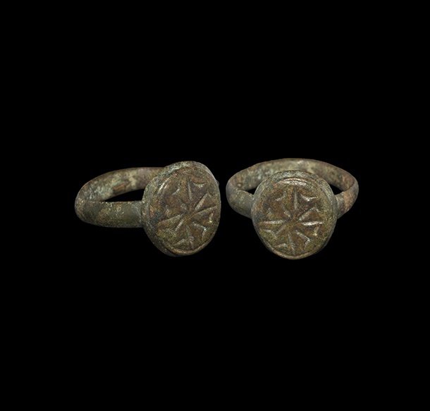 Byzantine Ring with Geometric Design: 9th-12th century AD. A D-section bronze hoop and discoid bezel with panel of radiating gamma-shaped motifs. From a Surrey, UK, collection; formed before 2000. 6.06 grams, 26mm overall, 18.14mm interna