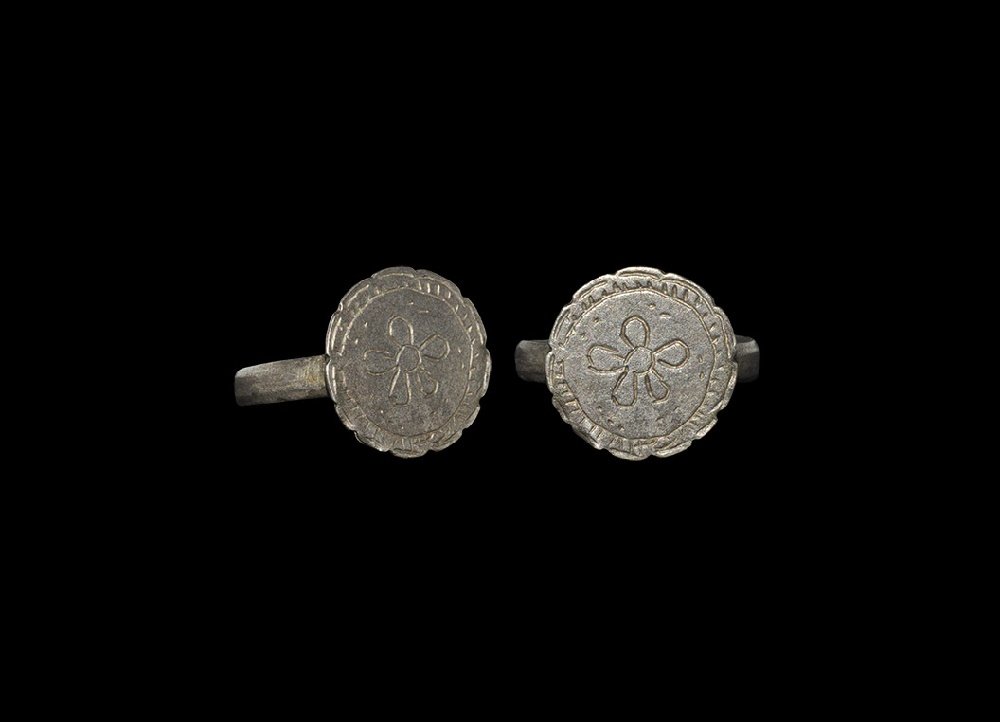 Byzantine Ring with Cinquefoil: 6th-10th century AD. A D-section silver hoop and discoid plaque with incised cinquefoil within a ropework frame, notched border. 2.88 grams, 21mm overall, 19.31mm internal diameter (approximate size B