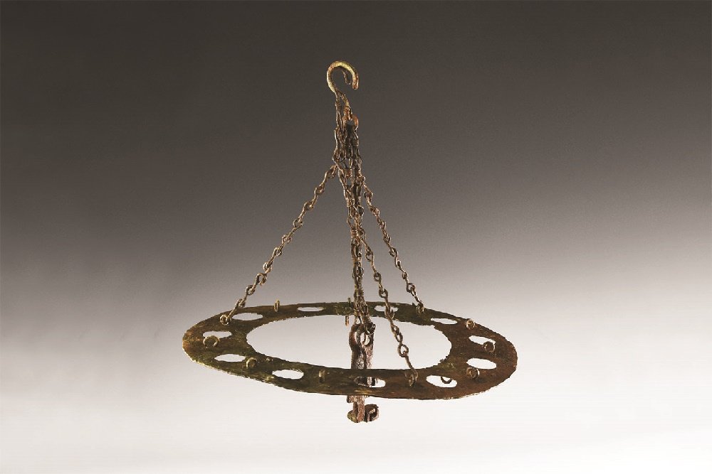 Byzantine Polycandelon with Key: 6th-7th century AD. An iron polycandelon, or chandelier, in the form of a ring with eleven holes to accept conical-shaped oil lamps; chain with hook attached for attachment to ceiling. 630 grams, 32cm