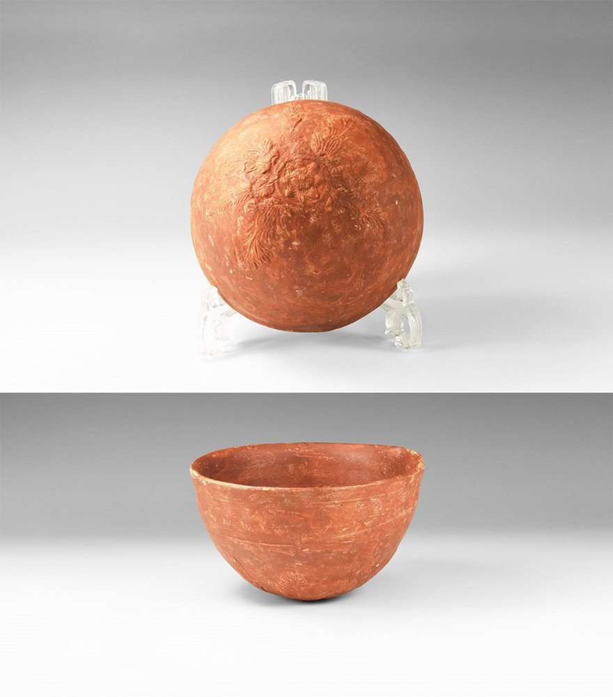 Roman Cup with Floral Decoration: 1st -3rd century AD. A ceramic terra sigillata cup with rounded underside, low-relief palmettes extending from the basal ring up the sides, undulating band below the rim. 229 grams, 14cm (5 1/2"). Fro