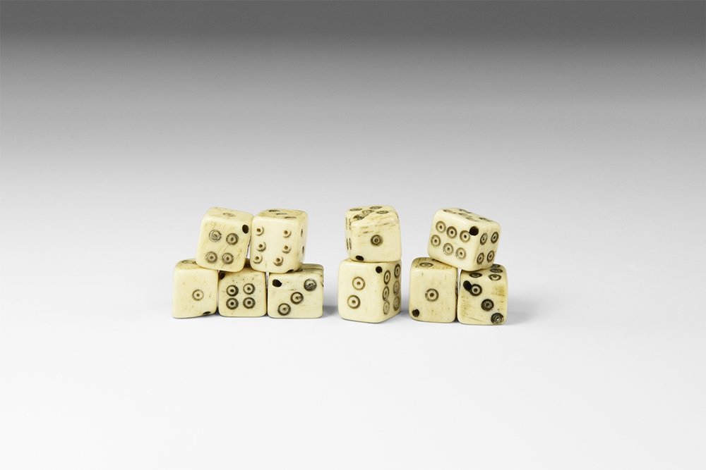 Byzantine Dice Group: 9th-14th century AD. A mixed group of ten bone cuboid dice; nine arranged 1:6, 2:5, 3:4 and one with two '6' faces arranged 1:6, 2:6, 3:4; each pierced diagonally for threading. 20 grams total, 9-12mm