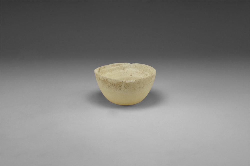 Egyptian Alabaster Bowl: Old Kingdom, 2686-2181 BC. A hemispherical alabaster bowl with flattened underside. 142 grams, 82mm (3 1/4"). Property of a private London collector; formerly in a 19th century collection.