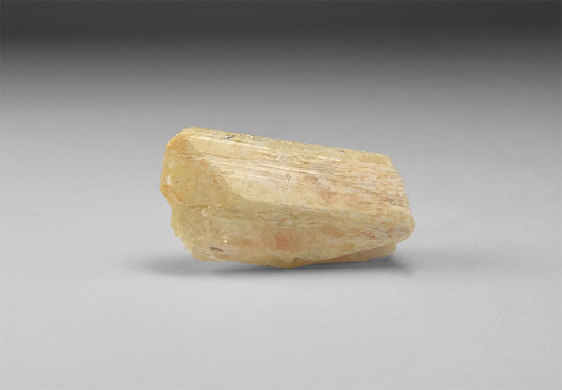Danburite Mineral Specimen.: A slightly orange danburite crystal in white card tray with label reading: 'DANBURITE, Charcas, San Luis Potosi, Mexico'. 41 grams, 54mm (2 1/4"). From the historic ‘Victorian Museum’ and later co