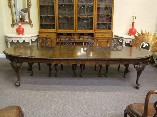 12 ft. GEORGIAN STYLE DINING TABLE: Exceptionally fine quality. Burl walnut with banded top. Rope edge and claw feet. Very good condition with some wear. 31"h. x 47"w. x 96" long, extends to 143" with one 47" board.