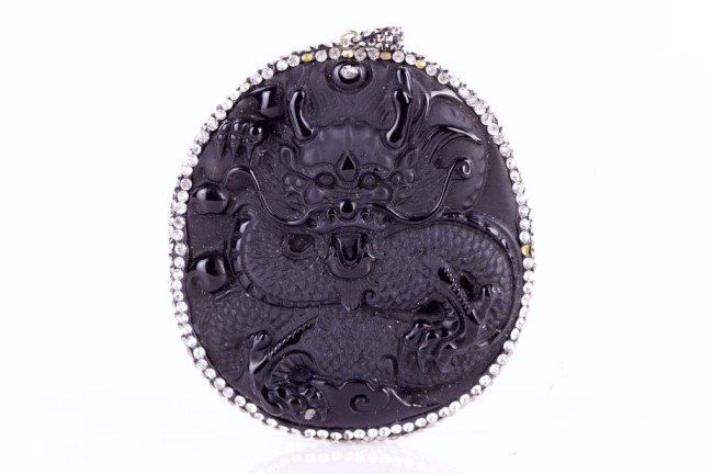 OBSIDIAN AMULET PENDANT: Carved with dragon. Surrounded by Zircons.