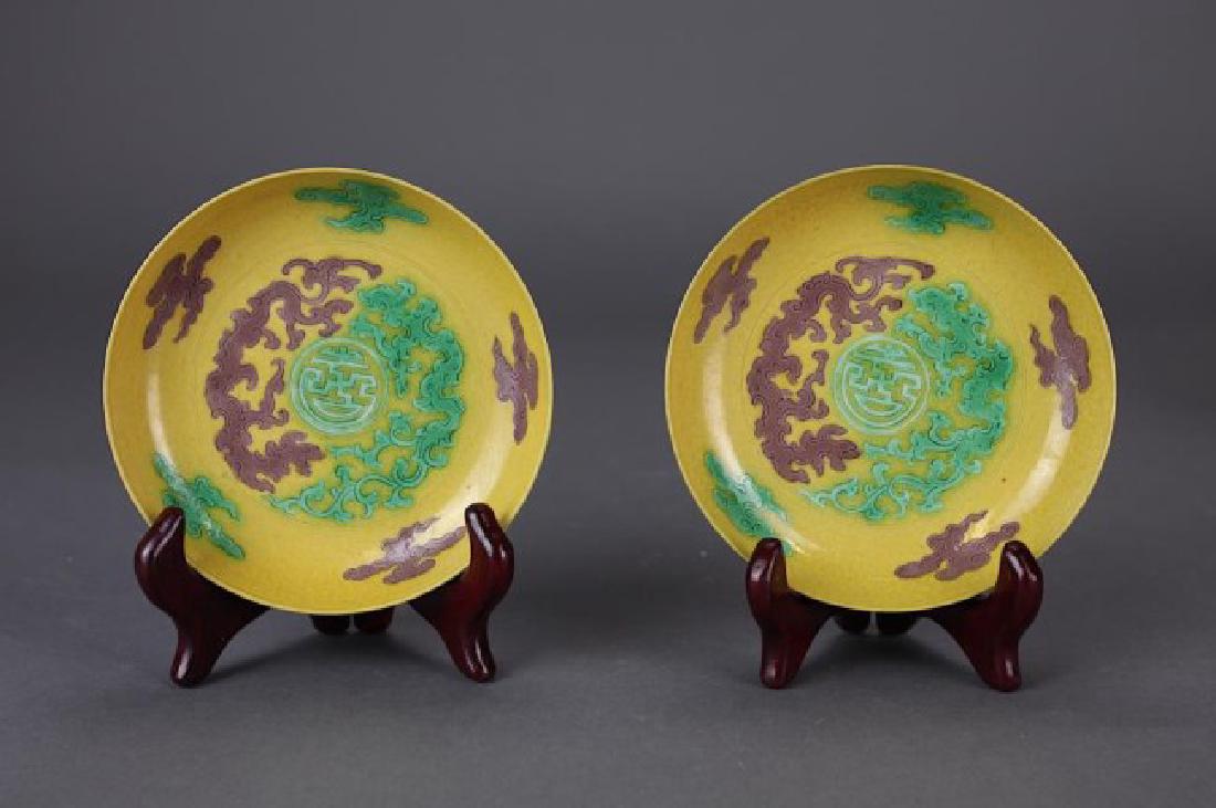 TWO YELLOW GROUND PLATES: With green and aubergine dragon decoration. Six characters mark to the bottom read Da Qing Yong Zheng. D: 5 1/8 in.