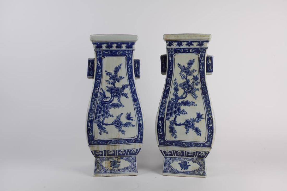 PAIR OF CHINESE BLUE AND WHITE SQUARE VASES: The vase is molded on the four sides painted with cobalt blue of "Four Gentleman among Flowers" and is flanked by two tube shaped handles. Six character mark of KangXi to the bottom. H: 17 1/8 in.