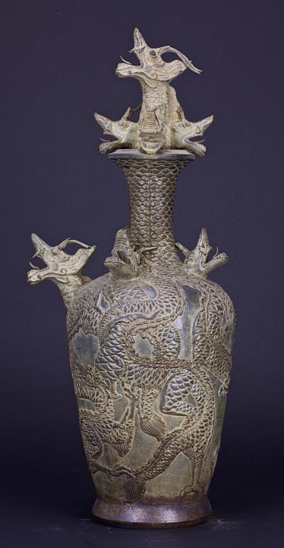 MAGNIFICENT KOREAN POTTERY 'DRAGONS' BALUSTER VASE: With a broad rounded shoulders and surmounted by a neck rising to an everted mouth. Magnificently carved with intertwining dragons with intricate fin details rising up to the mouth rim. Ornated with f