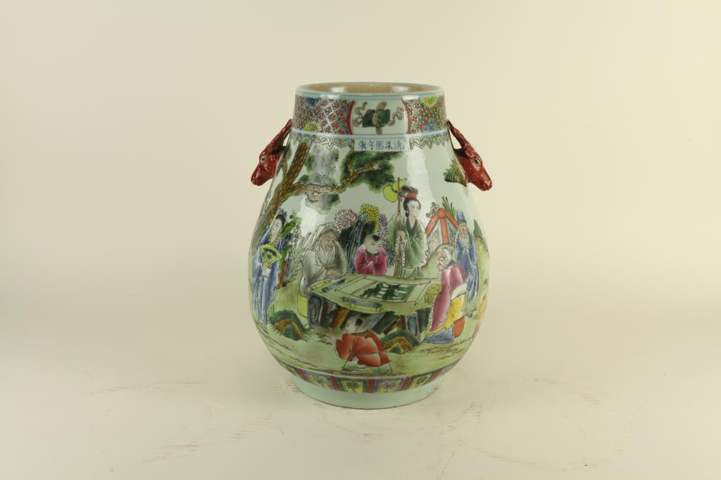 CHINESE FAMILLE ROSE HUNDRED DEER VASE, HU: The pear shaped body raised on a straight foot and flanked by a pair of deer head handles to the tapering upper section. Six character mark of Kangxi to the side. H: 15 3/4 in.