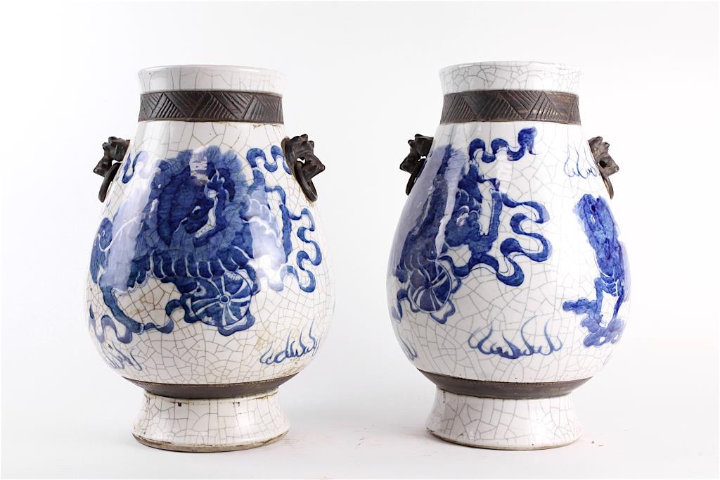 PAIR OF BLUE AND WHITE OX VASE: The pear shaped body raised on a straight foot and flanked by a pair of stylized foo dog handles to the tapering upper section. H: 14 1/8 in.