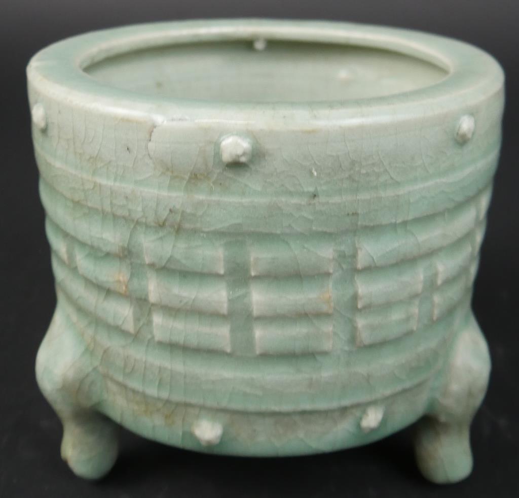 ROUND-SHAPED TRIPOD CONG JAR: Body decorated with a panel of three rows of raised ribs around standing on three curved legs. Red stamp on the bottom. H: 5 1/8 in.