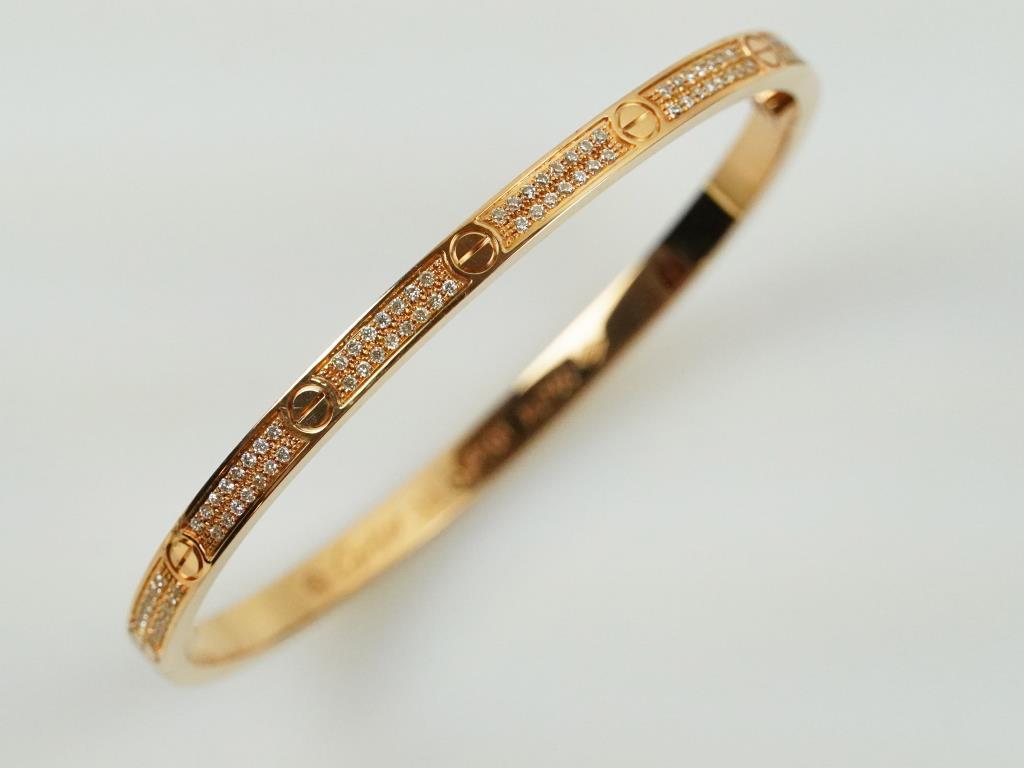 18K VINTAGE CARTIER-STYLE ROSE GOLD BANGLE: With diamonds, a total of 1.49ct.