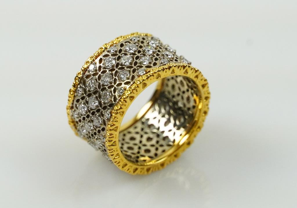 VINTAGE 18K GOLD AND DIAMOND WIDE BAND RING: Diamonds framed within 18k yellow gold trim.