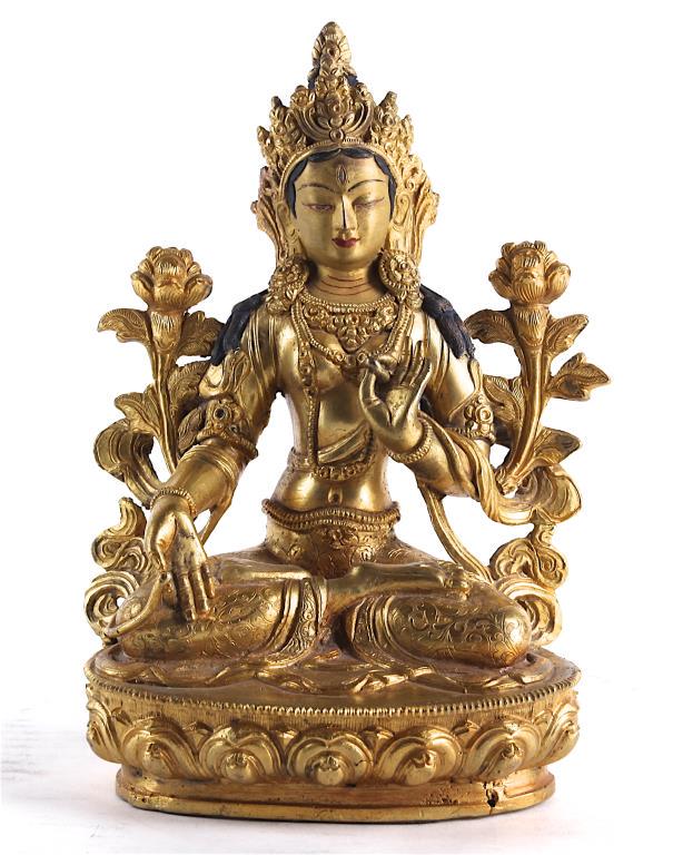 A GILT BRONZE FIGURE OF GREEN TARA: Cast seated in lalitasana on a double-lotus pedestal. The hands in varada mudra and vitarka mudra, flanked by lotuses rising to the shoulder. H: 8 1/4 in.