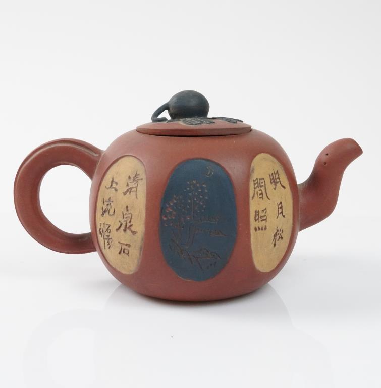 CHINESE YIXING CLAY TEAPOT WITH COVER: Decorated with panels of inscriptions and scenery around the body. Stamped mark on the bottom. H: 3 3/4 in.