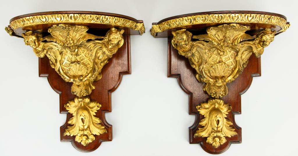 19TH CENTURY FRENCH GILTBRONZE WALL BRACKETS: 19th century. Cast with two faces and large leafy and c-scroll designs. With gilt bronze trim around top. H: 11 3/8 in.