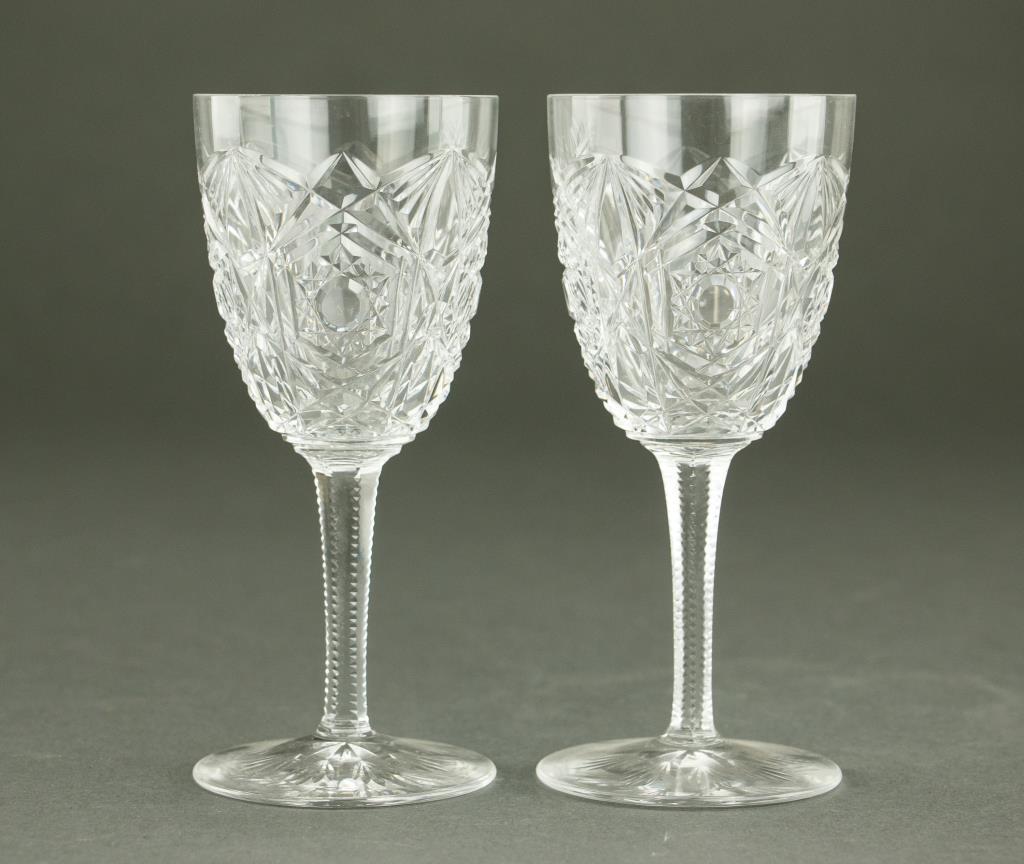 PAIR OF BACCARAT CUT CRYSTAL WINE GLASSES: With gorgeous geometric decoration around each of the glasses. H: 5 3/4 in.