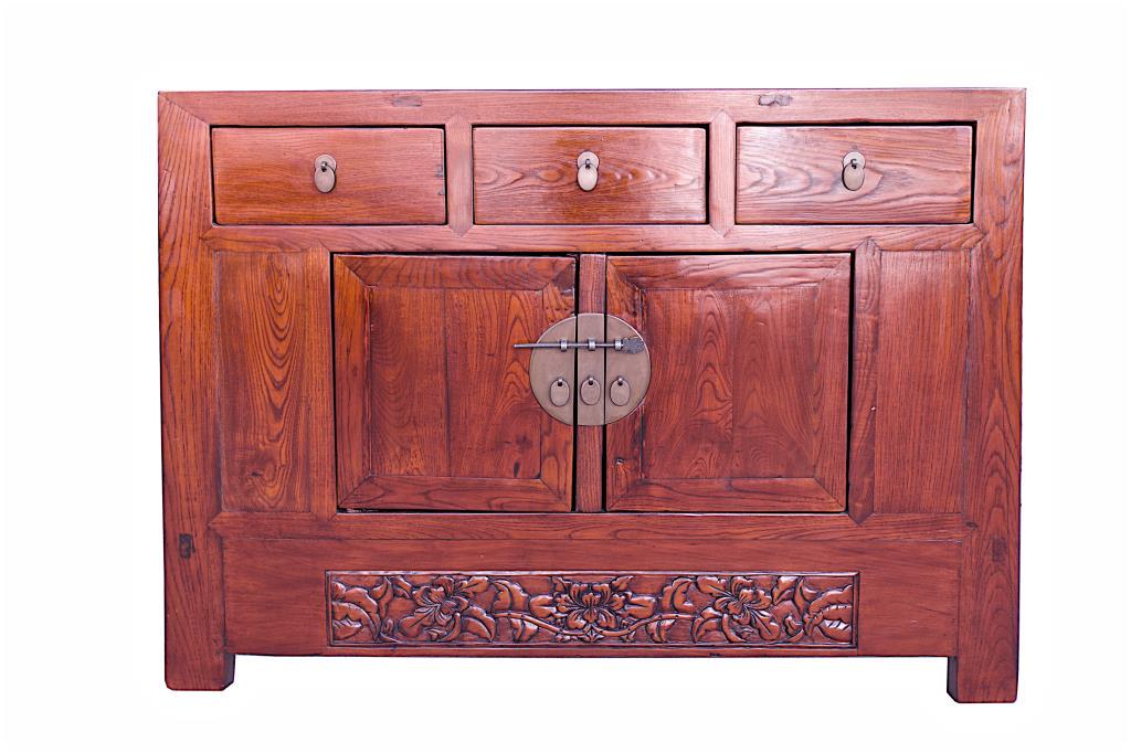CHINESE CARVED WOOD CABINET: The cabinet constructed on one side with three drawers with round plates and oval handles above a two door cabinet set with a circular plate and key bolt. With peony carving to the bottom.
