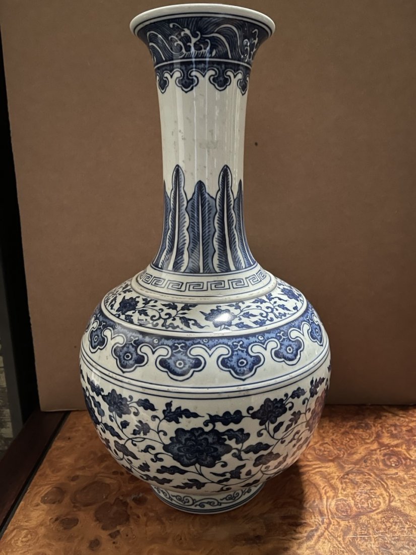 CHINESE BLUE AND WHITE GLOBULAR VASE: Body painted with meandering flowers and tendrils between borders of ruyi heads and scrolling leaves, while the neck has overlapping banana leaves under pendants of scepters below crashing waves aroun