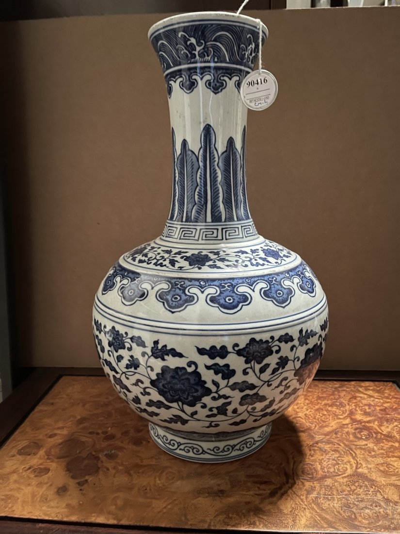 CHINESE BLUE AND WHITE GLOBULAR VASE: Body painted with meandering flowers and tendrils between borders of ruyi heads and scrolling leaves, while the neck has overlapping banana leaves under pendants of scepters below crashing waves aroun