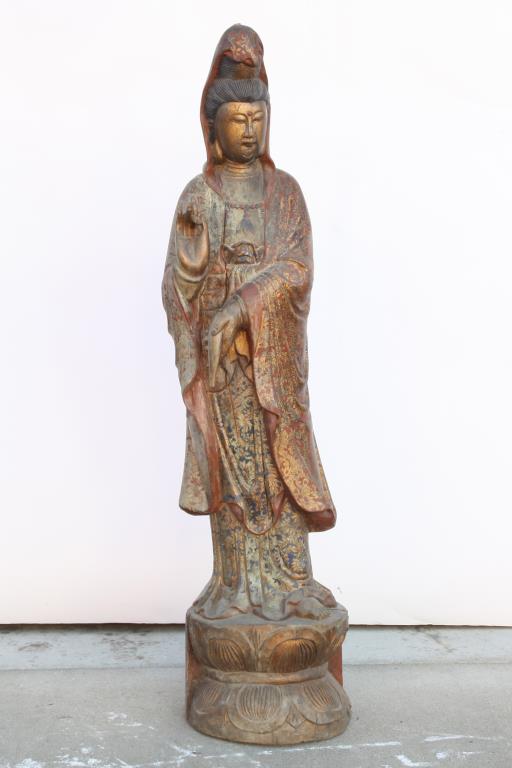 ANTIQUE CHINESE CARVED WOOD STATUE OF A GUANYIN: In long flowing gown, her hair in high bun, and standing on double pedestal. H: 40 in.