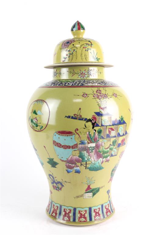 CHINESE FAMILLE JAUNE LIDDED TEMPLE JAR: Beautifully painted with a figural scene with numerous auspicious objects around the body, against a yellow background. Six-character double-ring mark to read Kangxi to the bottom. H: 21 in.