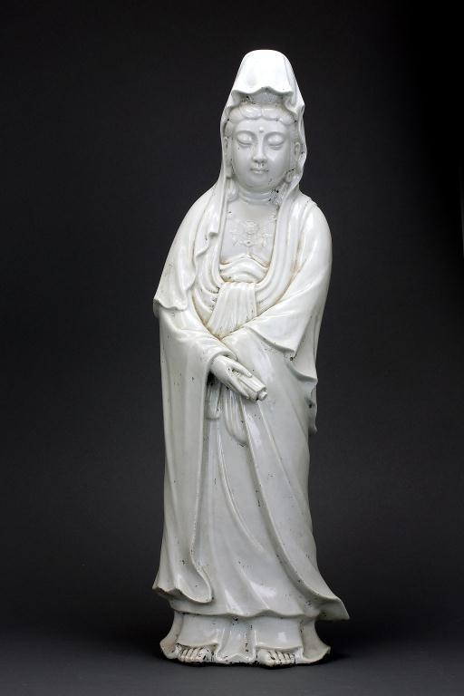 BLANC DE CHINE CHINESE PORCELAIN GUANYIN: Wearing a billowy robe and veil, and holding a scroll on her right hand. H:24 1/2 in. (62cm)
