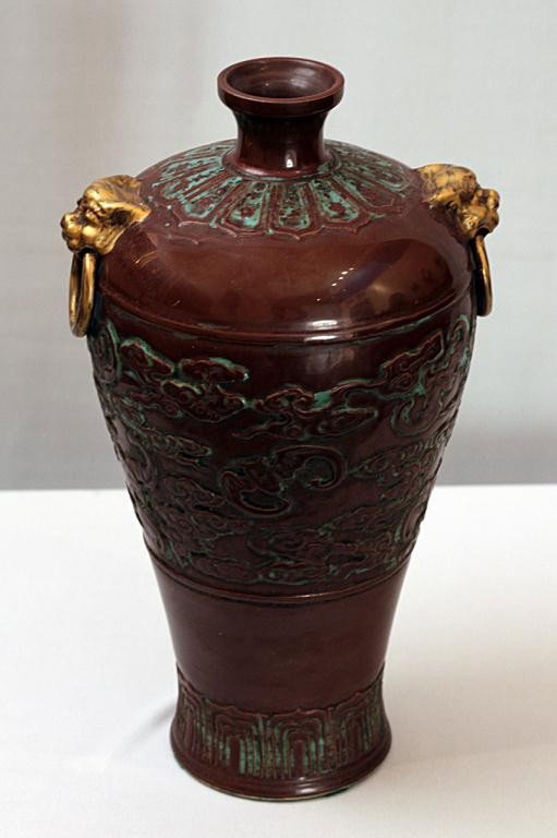 DEEP BROWN CHINESE TAPERING BALUSTER VASE: H:12 7/8", with gilded two lion-headed ring handles and rings, with raised carving depicting of bats flying in between clouds