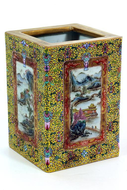 CHINESE FAMILLE JAUNE SQUARE BRUSH POT: H: 8 3/8" x W: 6" x L: 5 3/4", with four landscape panels within a border of bats and shous, while the rest of the body is surrounded by flowers and auspicious gifts on yellow ground
