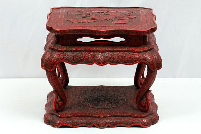 HAND-CARVED CHINESE CINNABAR LAQUER STAND: H: 8 1/8" (20cm) x L: 9 1/4" (23cm), exquisitely carved miniature étagère; top shelf in cartouche shape depicting of a phoenix in flight amid clouds on a diamond pattern ground within a double recta