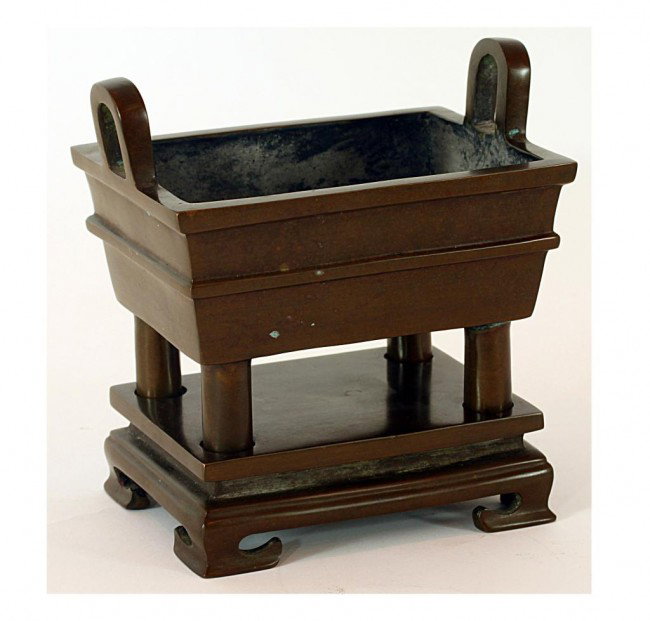 CHINESE BRONZE INCENSE BURNER WITH STAND: H: 6 1/3" (16cm), of rectangular shape having two inverted "U" handles, on four cylindrical legs fitted well on a rectangular platform raised with four short everted feet