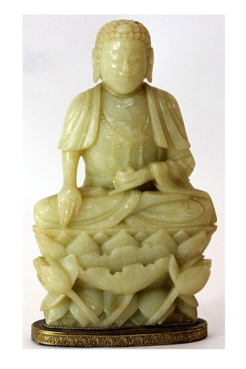 SOAPSTONE CARVED FIGURE OF A SEATING BUDDHA: H: 9 3/4" (24cm), in meditative position on lotus flowers, lined and fitted in gilt bronze oval base with shell border