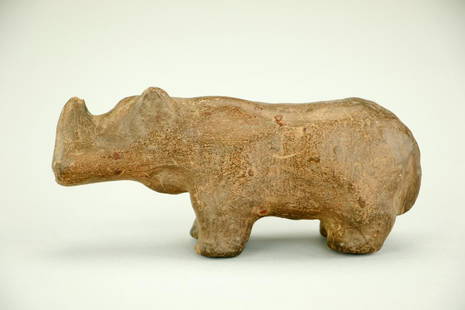 CLAY FIGURE OF A RHINO, POSSIBLY HAN DYNASTY: In standing position. H: 2 1/4 in., L: 5 1/4 in.