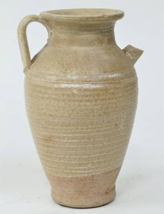 SMALL CHINESE POTTERY EWER: Flanked by a handle and a spout on the shoulder, with a flared rim. With ribbed design around the body. H: 5 1/2 in.