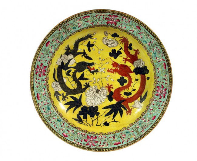 LARGE CHINESE SHALLOW DISH WITH DRAGONS: Diameter: 15 3/4 in. (40cm) , with two four clawed dragons in the interior, one black and gold, one in coral color, both amidst flowers. The exterior is bordered by ruyi heads, meandering flowers in l