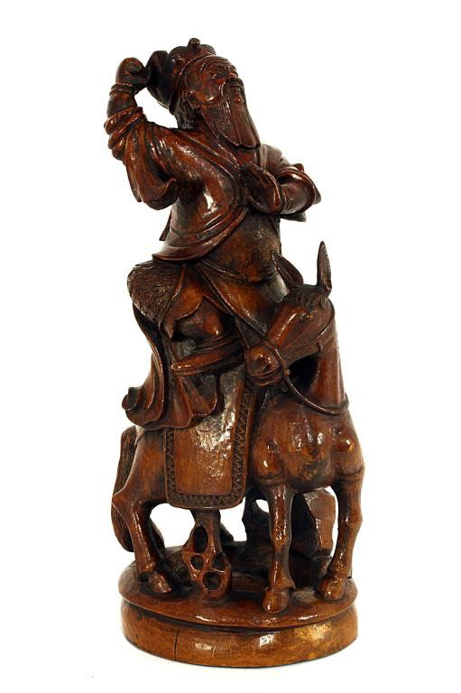 CHINESE BAMBOO CARVING OF A SOLDIER ON A HORSE: H: 11 1/2 in. (29cm), wearing a battle gear, his intense face matched the twist of his body ready to throw a (missing) weapon with his right hand, and left hand in place to keep his balance while aboa