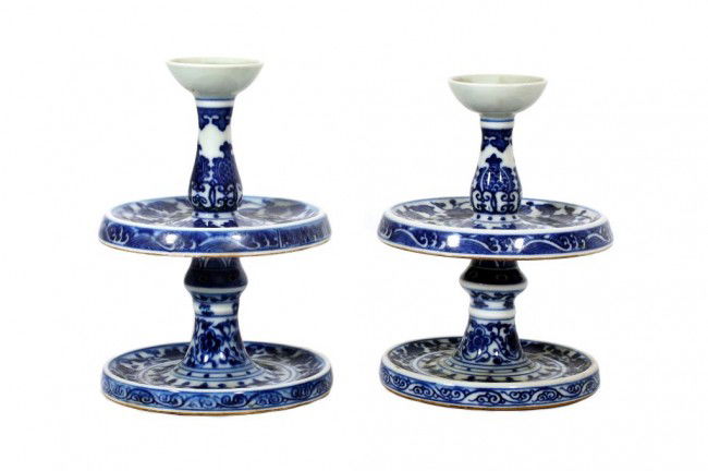 PAIR OF CHINESE BLUE AND WHITE CANDLE HOLDERS: H: 4 3/4" in. (12cm), each having a slender sectional form with a circular dish, all on a slightly smaller cylindrical base, hand-painted with meandering flowers and leaves