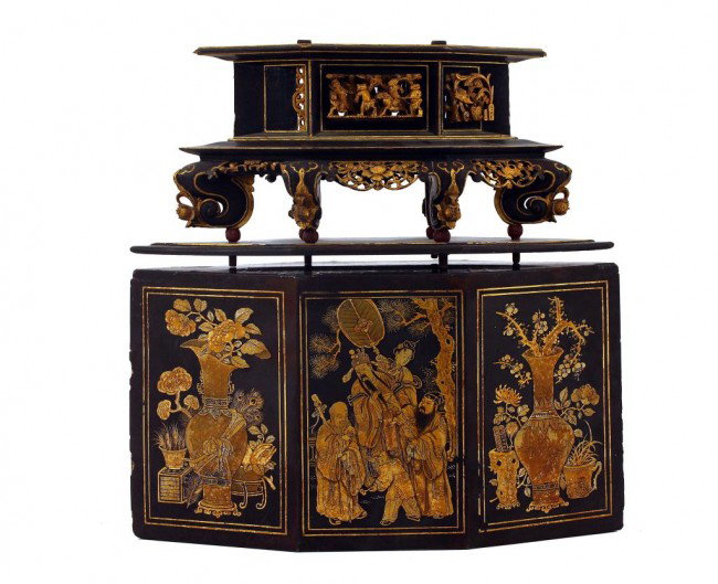 SMALL SIX-PANEL CARVED WOODEN SHRINE STAND: H: 15 in. (38cm), possibly an ebonized three-part shrine stand (top missing), surmounted with a carved gilt wood figural celebrations raised by six cabriole legs bearing flower heads on ball, bottom i