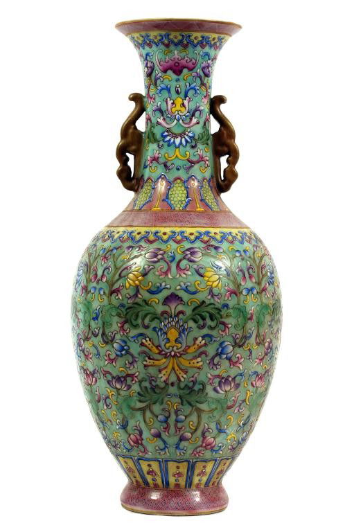 CHINESE FAMILLE ROSE BOTTLE NECK VASE WITH HANDLES: H: 13 in. (33cm), of ovoid shape below a long neck with flared rim, finely carved in relief and enameled with flowers and foliage between borders of ruyi heads and lappets, the shoulder with a band of